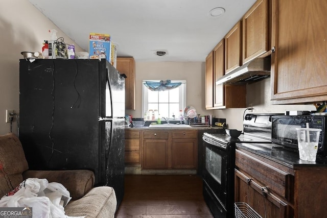 kitchen with dark wood-type flooring, black appliances, and sink