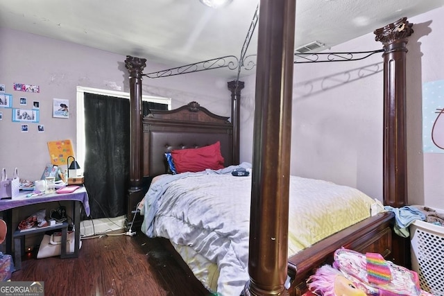 bedroom with hardwood / wood-style floors