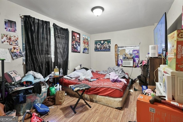 bedroom featuring hardwood / wood-style floors and cooling unit