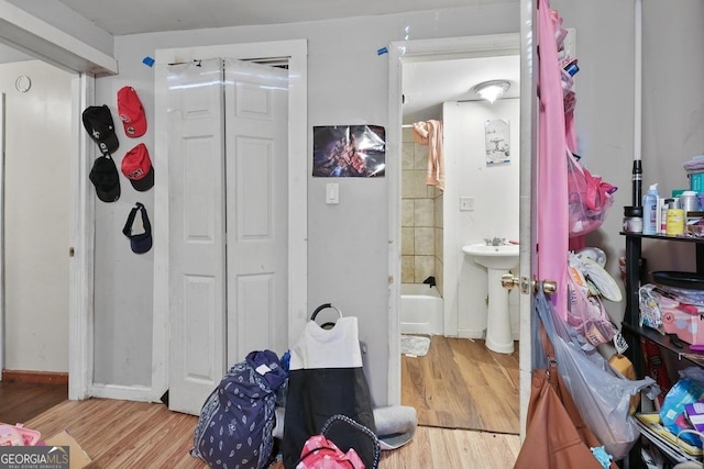 bathroom with sink, tub / shower combination, and wood-type flooring