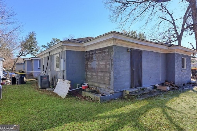 view of property exterior with a yard and cooling unit