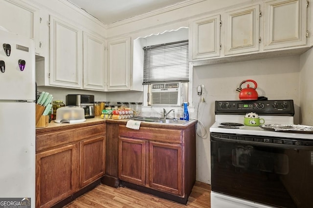 kitchen with white refrigerator, range with electric cooktop, sink, ornamental molding, and light wood-type flooring