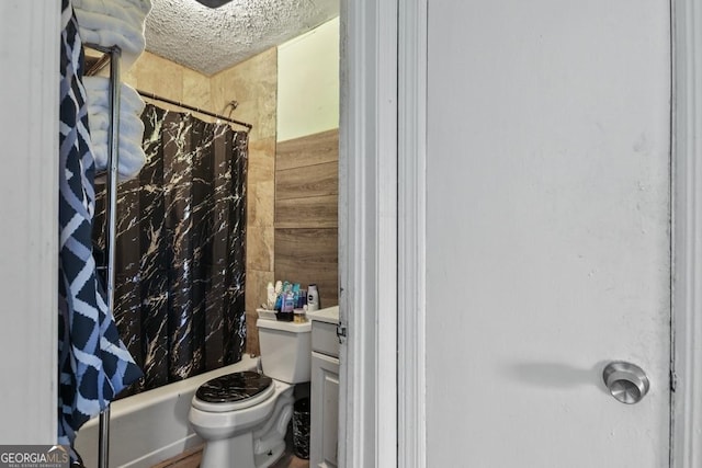 full bathroom with toilet, a textured ceiling, shower / bathtub combination with curtain, and vanity