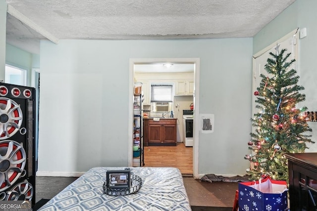 bedroom featuring a textured ceiling and cooling unit