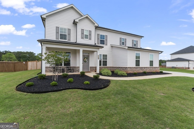 view of front of house featuring covered porch and a front yard