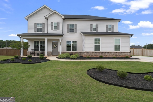 view of front facade with a front yard and covered porch