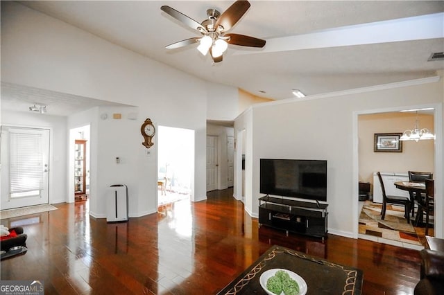 living room featuring ceiling fan with notable chandelier, dark hardwood / wood-style flooring, crown molding, and lofted ceiling