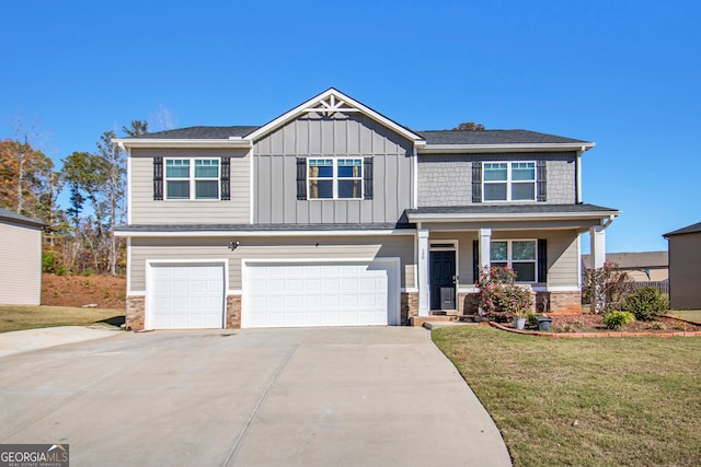 craftsman-style house featuring covered porch, a garage, and a front lawn