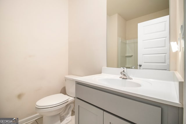 bathroom featuring a shower, vanity, toilet, and tile patterned flooring