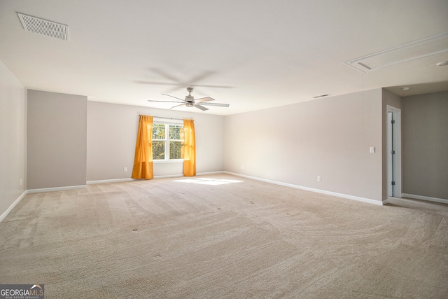 carpeted spare room with ceiling fan