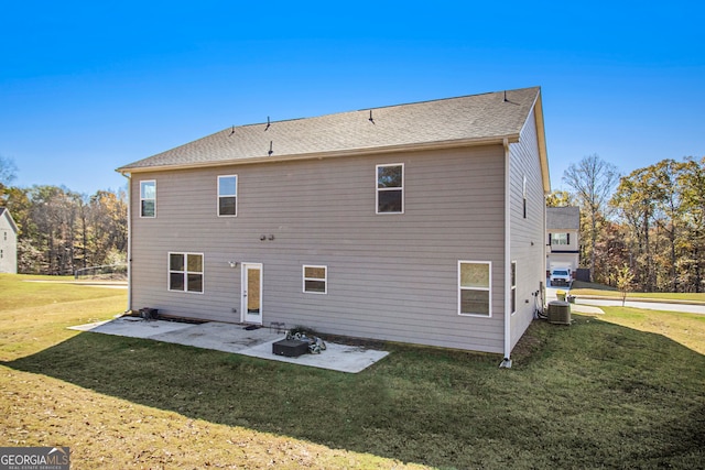 back of property with cooling unit, a patio area, and a yard