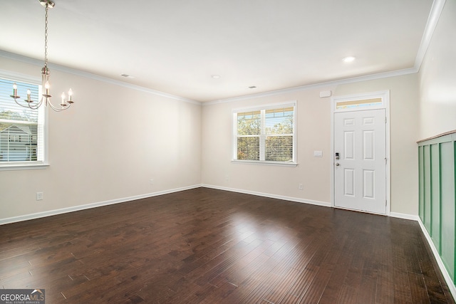 entryway featuring a notable chandelier, dark hardwood / wood-style flooring, and crown molding