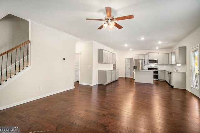 unfurnished living room with dark hardwood / wood-style flooring, ceiling fan, ornamental molding, and sink