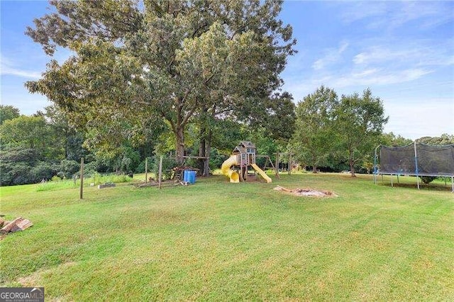 view of yard featuring a playground and a trampoline