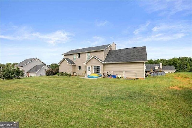 rear view of house with a yard