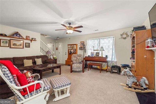 carpeted living room with ceiling fan