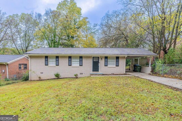 single story home featuring a front lawn and a carport