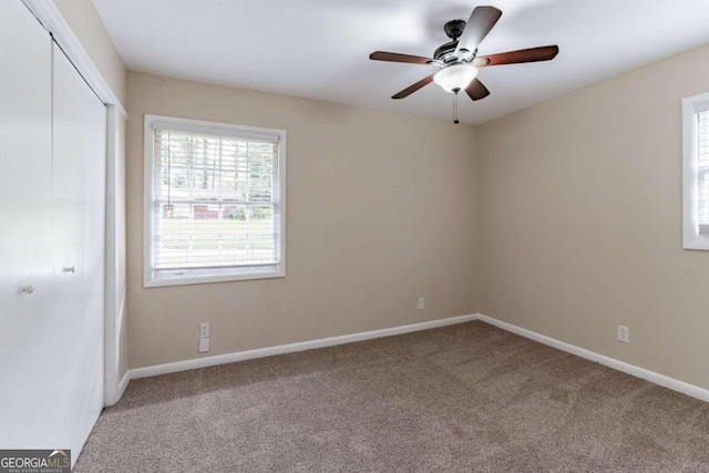 unfurnished room with carpet floors and ceiling fan