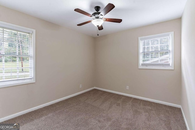 spare room featuring carpet flooring and ceiling fan