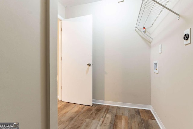 clothes washing area with hookup for a washing machine and light hardwood / wood-style flooring