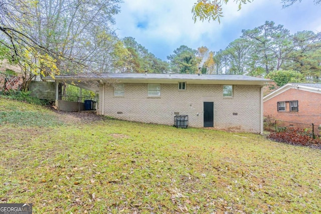 rear view of house featuring a lawn