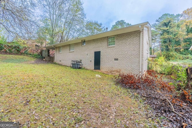 rear view of property with a yard