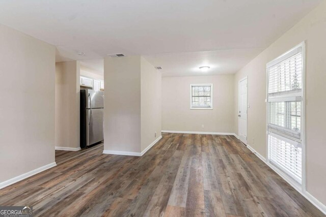 empty room with dark wood-type flooring