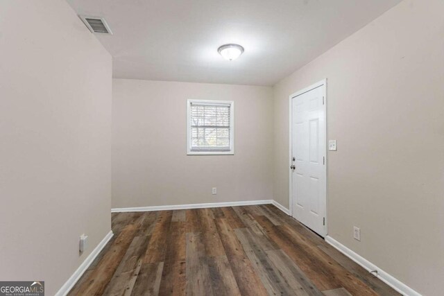 spare room featuring dark hardwood / wood-style floors