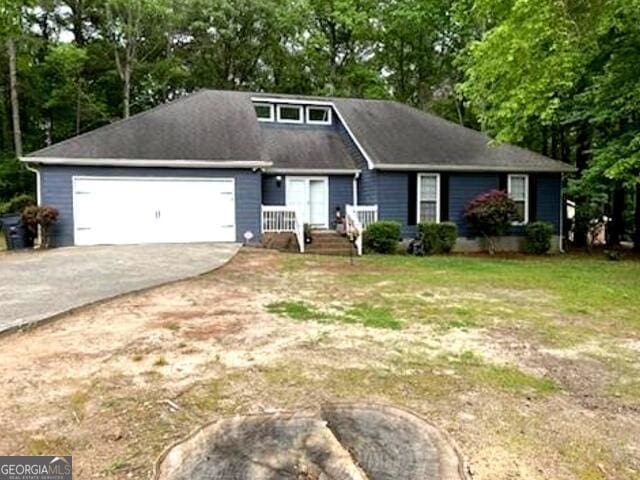 view of front of house with a front yard and a garage