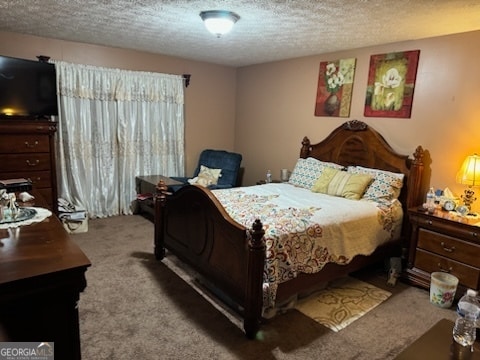 bedroom with a textured ceiling and carpet floors