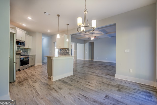 kitchen featuring decorative backsplash, light hardwood / wood-style flooring, white cabinets, and stainless steel appliances