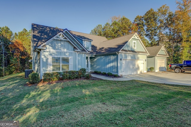 view of front of home with central AC unit, a garage, and a front yard