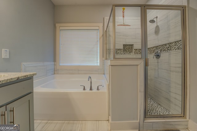 bathroom with shower with separate bathtub and vanity