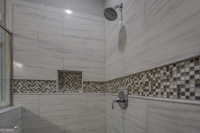 bathroom featuring a tile shower and tile walls