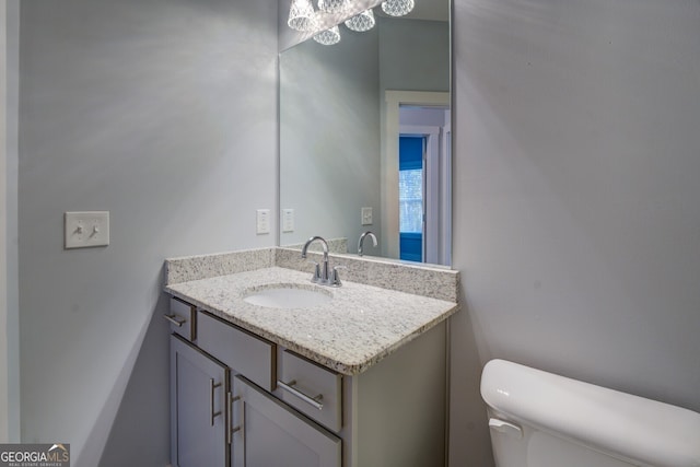 bathroom featuring vanity and toilet