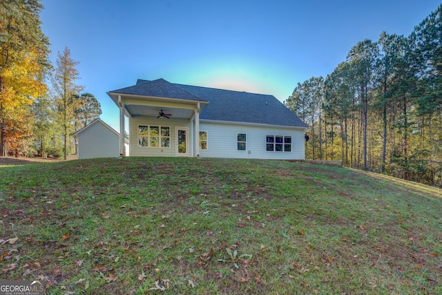 back of property with a lawn and ceiling fan