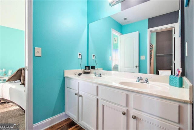 bathroom featuring toilet, vanity, and hardwood / wood-style flooring