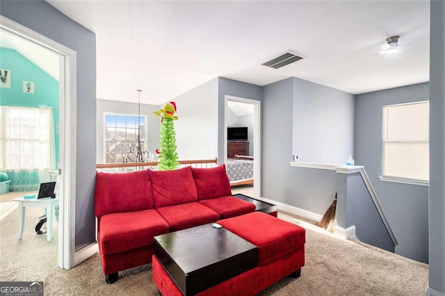 living room with carpet floors and vaulted ceiling