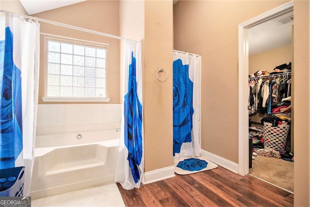 bathroom with hardwood / wood-style flooring, independent shower and bath, and lofted ceiling