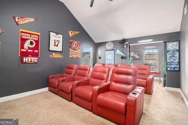 cinema room featuring plenty of natural light, carpet floors, and vaulted ceiling