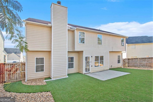 back of house featuring a yard and a patio