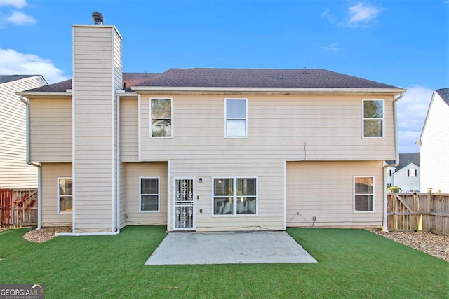 back of house featuring a patio area and a yard