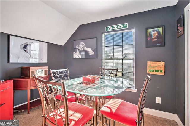 dining space with carpet flooring and lofted ceiling