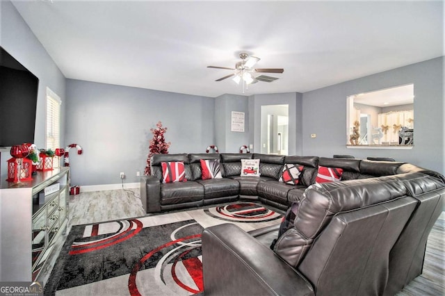 living room featuring hardwood / wood-style flooring and ceiling fan