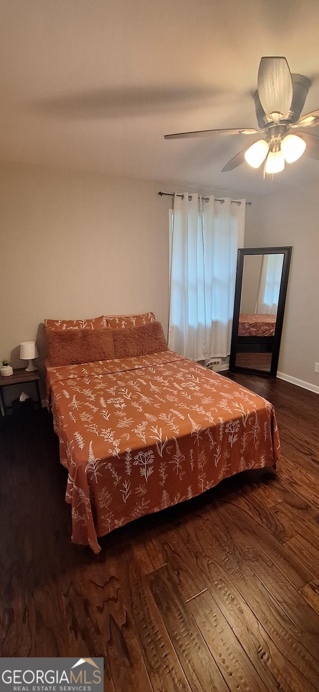 bedroom featuring ceiling fan and dark wood-type flooring