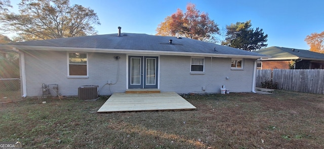 back of house with a yard and cooling unit