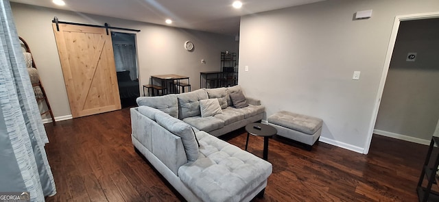 living room featuring dark hardwood / wood-style flooring and a barn door