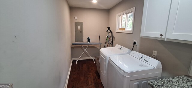 laundry area with electric panel, separate washer and dryer, dark hardwood / wood-style flooring, and cabinets