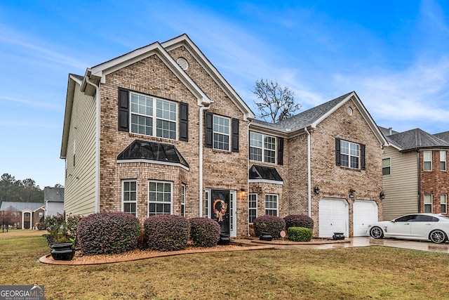 view of front of home with a garage and a front lawn