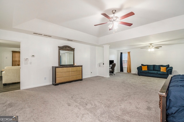 carpeted living room with ceiling fan